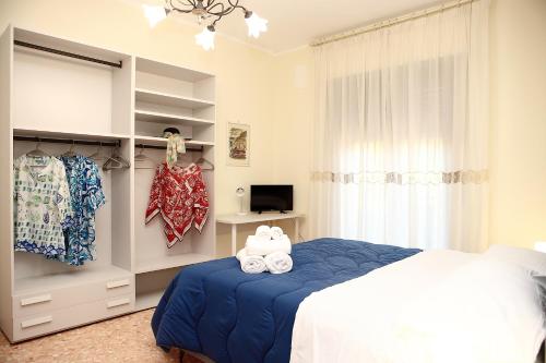 a bedroom with a bed and a tv and a window at VicoStay di Casa Stella in Vico Equense