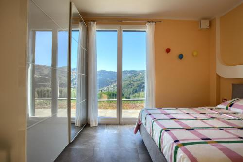 a bedroom with a bed and a large window at Iris - Costadoro Holiday Home in Imperia