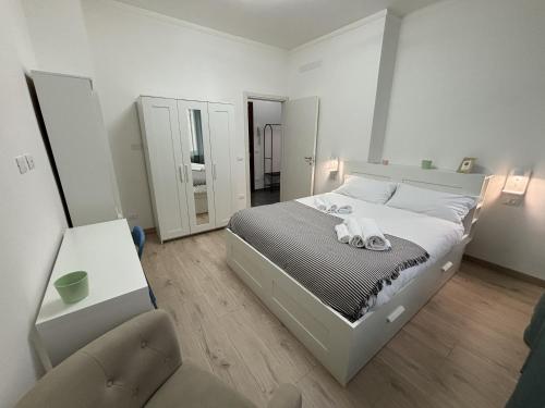 a bedroom with a large bed and a chair at Arcobaleno in Turin