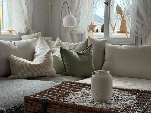 a living room with a couch with pillows and a table at Haus Bergverliebt in Sebnitz