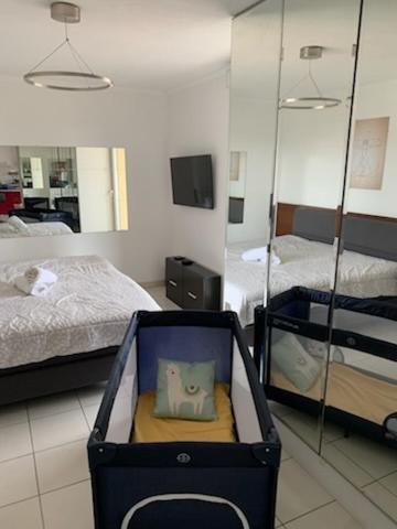 a suitcase with a cat pillow in it in a bedroom at Droit au but!! in Marseille