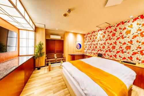 a hotel room with a large bed in a room at HOTEL ATLANTIS IKUTAMA -Adult Only in Osaka