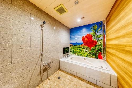 a bathroom with a large painting of a flower on the wall at HOTEL ATLANTIS IKUTAMA -Adult Only in Osaka