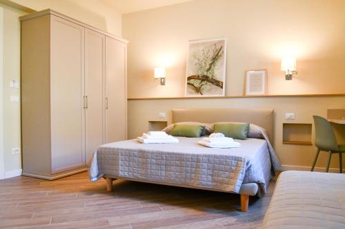 a bedroom with a bed with two towels on it at Agriturismo De Ferrari in Onzo