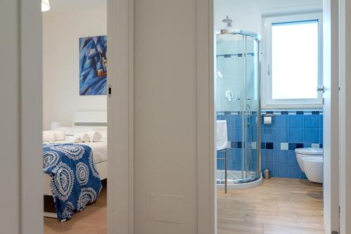 a bathroom with a bed and a shower and a sink at Brezza marina in Mola di Bari