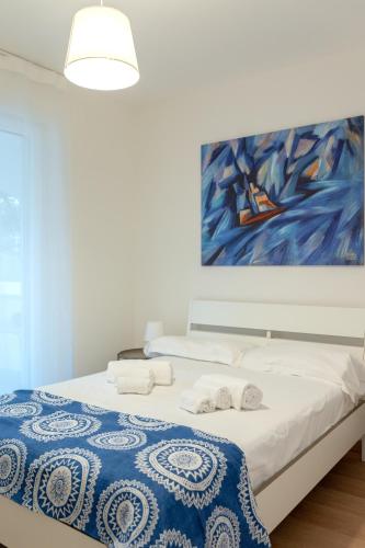 a bedroom with a bed with a painting on the wall at Brezza marina in Mola di Bari