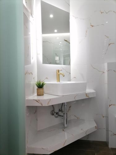 a bathroom with a sink and a mirror at Sfendamos Residence Kavala in Kavála