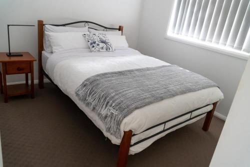 a bed in a bedroom with a pillow on it at Luxurious 3 Bedroom Executive Home-Private Retreat in Higgins