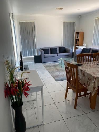 a living room with a table and a couch at Luxurious 3 Bedroom Executive Home-Private Retreat in Higgins
