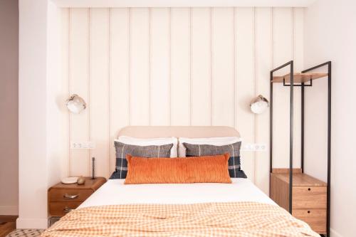 a bedroom with a bed and a striped wall at Genesis-Loft Madrid in Madrid