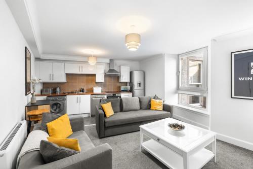 a living room with a couch and a table at Commercial Street Residence in Dundee