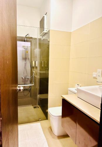 a bathroom with a toilet and a sink and a shower at Sea view Serenity Negombo in Negombo