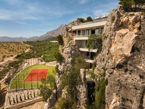 a building on the side of a mountain at Villa Kuk Oaza in Makarska