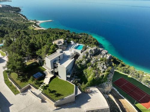 an aerial view of a house on a cliff next to the ocean at Villa Kuk Oaza in Makarska