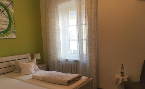 a bedroom with a bed and a window at Landhotel Steffen in Lieser