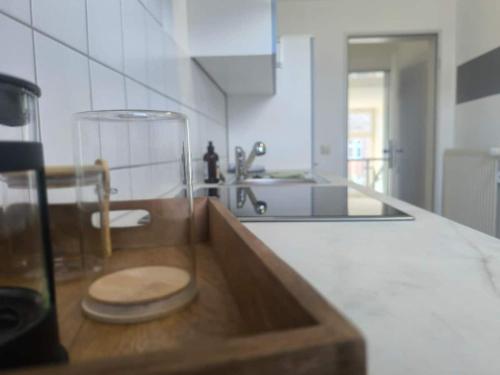 a kitchen with a sink with a glass bowl on a counter at Ruhige Ferienwohnung NB in Neubrandenburg