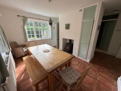 a living room with a wooden table and chairs at The lodge in Bodmin