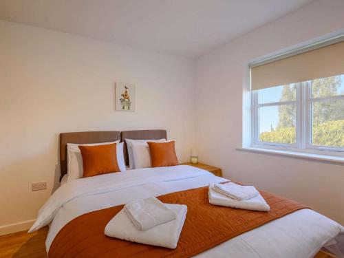 a bedroom with a large bed with two towels on it at 2 Bed in Louth oc-53508 in Fotherby