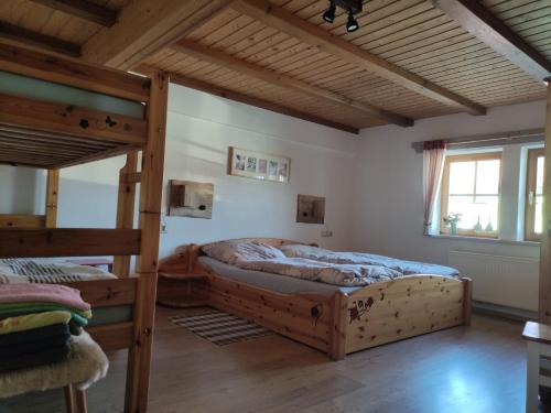 a bedroom with two bunk beds and a wooden ceiling at Familienferienhof Sell´s Scheune in Sundhausen