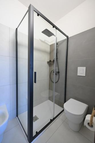 a bathroom with a shower with a toilet and a sink at Camere da Angelo in Tortolì