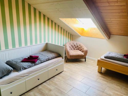 a room with a bed and a chair in it at Das Vogelnest in Mössingen