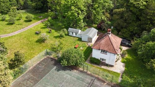 an aerial view of a small white house on a field at Cosy Cottage with Large Garden I Semi Rural Retreat! Nearby Countryside, Beaches & Goodwood - Chichester Holiday Properties in Eartham