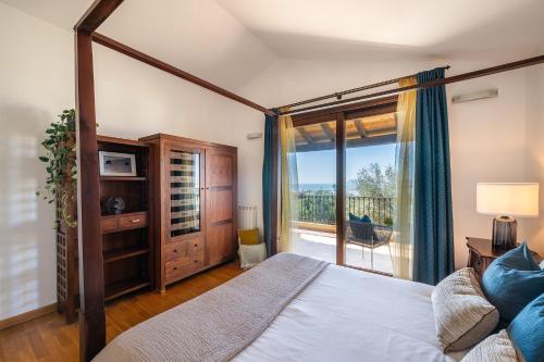 a bedroom with a large bed and a balcony at Cagliari Bay View Villa in Quartu Sant'Elena