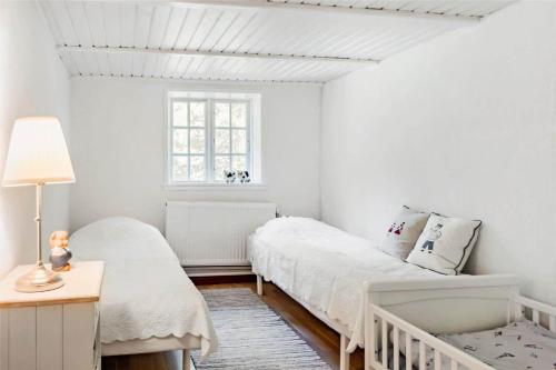 a white bedroom with two beds and a window at OH397-Storvorde-Kystvej-171 in Storvorde