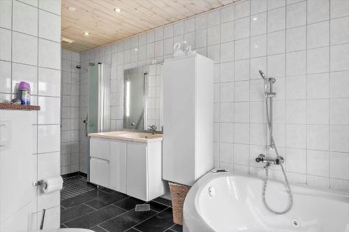 a bathroom with a tub and a toilet and a sink at OH357-Storvorde-Hybenvej-40 in Storvorde