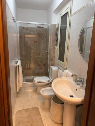 a bathroom with a toilet and a sink and a shower at Angel house airport in CTA