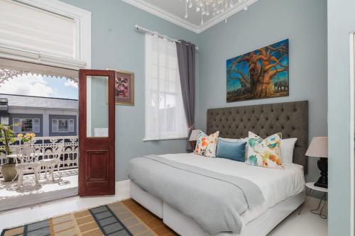 a bedroom with a bed and a window at The Willets Boutique Hotel in Simonʼs Town
