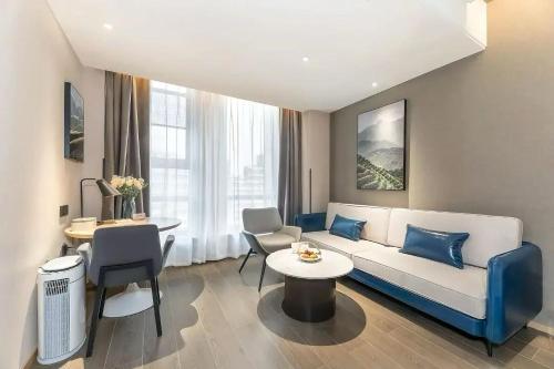 a living room with a couch and a table at Atour Hotel Zhijiang Bridge in Hangzhou