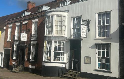 a white building with white windows on a street at Colchester Boutique Hotel in Colchester