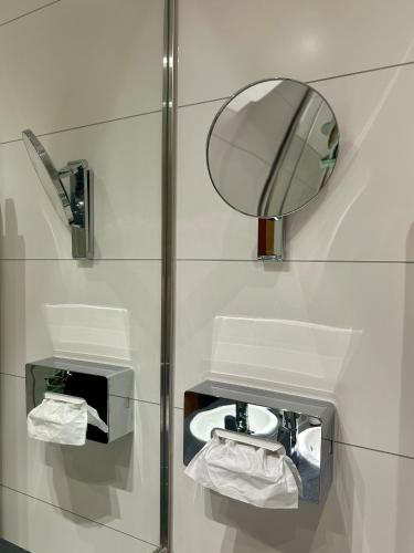 a bathroom with a mirror and a toilet at Hotel am Kurpark in Schönebeck