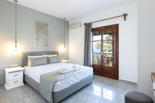 a bedroom with a large bed and a window at Olga Villa in Megali Ammos