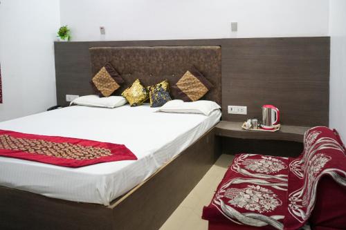 a bedroom with a large bed with a wooden headboard at Hotel satkar in Parāsia