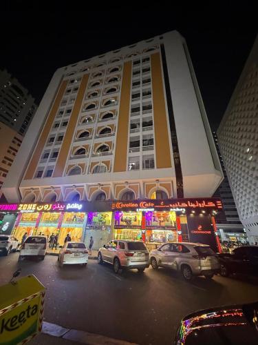 a large building with cars parked in front of it at Grand International in Abu Dhabi