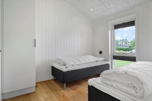 a bedroom with two beds and a window at OH513-Hadsund-Haslevgarde-Eng-14 in Hadsund