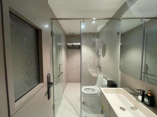 a bathroom with a shower and a toilet and a sink at Leonora Hotel in Ho Chi Minh City