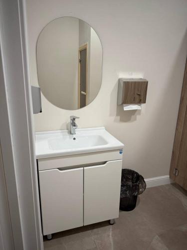 a bathroom with a white sink and a mirror at Fresh hostel in Almaty