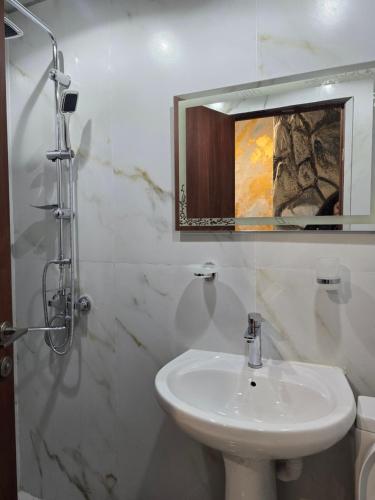 a bathroom with a sink and a mirror at Hirmas boutique hotel in Tbilisi City