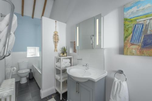 a white bathroom with a sink and a toilet at 1 Bed in Lowick oc-coq44 in Holburn