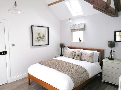 a bedroom with a bed with white walls at 1 Bed in Lowick oc-coq46 in Holburn