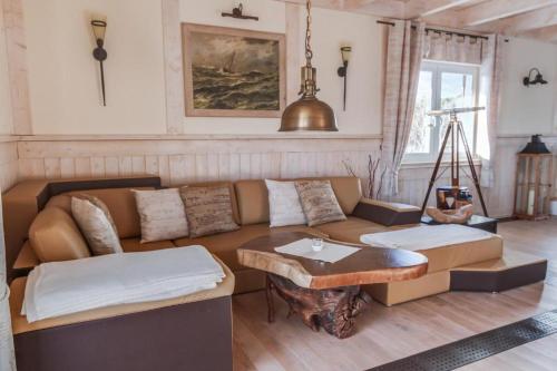 a living room with a couch and a table at Penthouse Meeresrauschen in Dierhagen