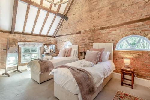 a room with two beds and a brick wall at 2 Bed in Caenby oc-o35799 in Caenby
