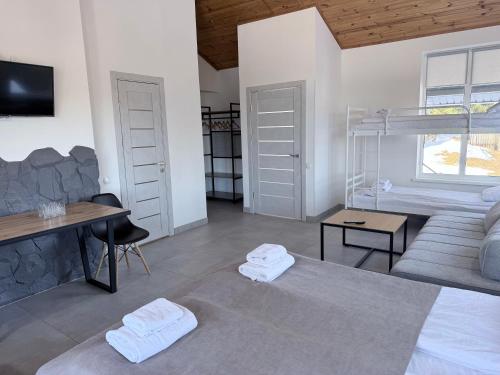 a living room with a bed and a couch at Готель Яблуниця in Yablunytsya
