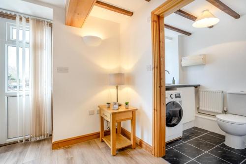 a bathroom with a toilet and a mirror at 2 Bed in Knayton oc-b35995 in Knapton