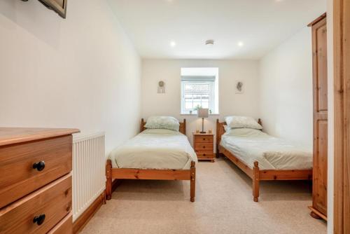 a bedroom with two twin beds and a dresser at 2 Bed in Knayton oc-b35995 in Knapton