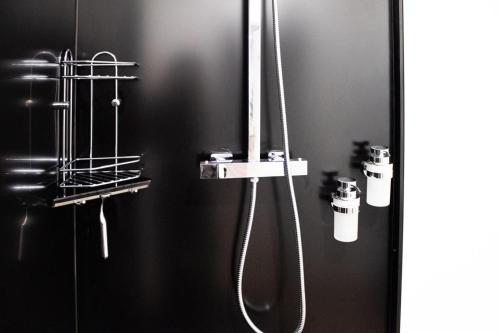 a bathroom with a shower with two shower heads at Lucky Strike Hostel in Bad Oldesloe