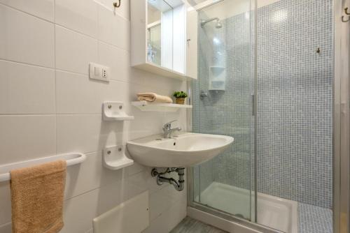 a bathroom with a sink and a glass shower at L13 Terrazza Levante in Stintino